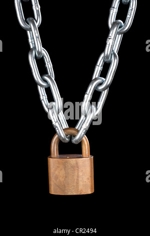 A vintage brass lock connecting a thick, chrome chain isolated on black. Stock Photo