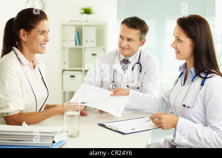 Medical assistant giving the prescription to the smiling patient Stock Photo