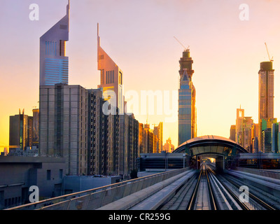 Modern city at sunset, metro overpass with rails, Dubai city in United Arab Emirates , Stock Photo