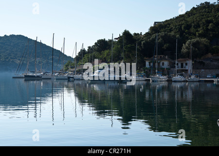 Yachts moored in the early morning mist in the harbour at Sivota, Lefkas, Greece Stock Photo