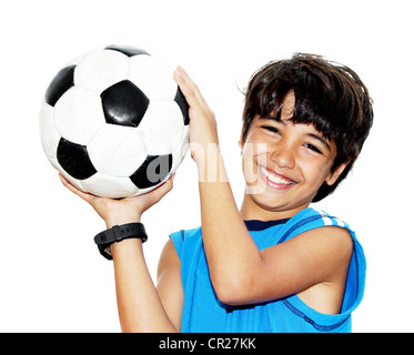 Cute boy playing football, happy child, young male teen goalkeeper enjoying sport game, holding ball, little footballer Stock Photo