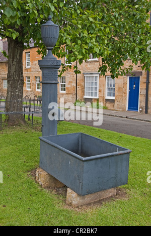 Old metal water pump and trough on village green, Chipping Campden Stock Photo