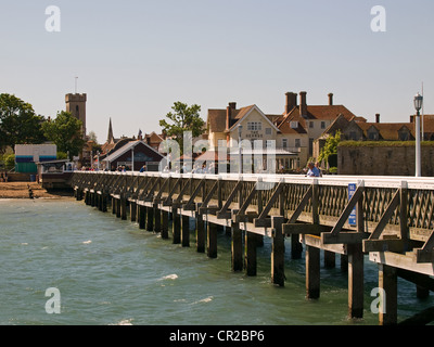 Victorian wooden pier Yarmouth Isle of Wight England UK with the George Hotel and part of Yarmouth Castle in the background Stock Photo