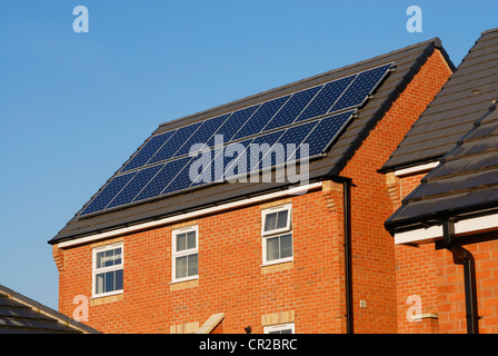 Modern house with solar power panels on the roof. Stock Photo