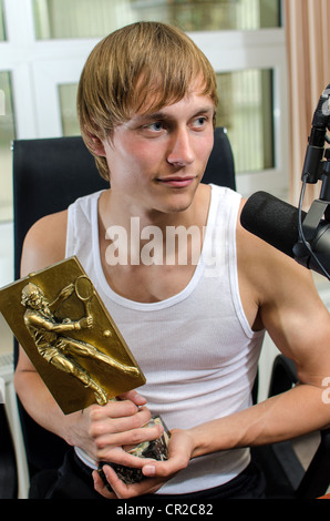 Tennis player with a prize on the radio station Stock Photo