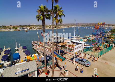 Vintage three-car ferryboats cross Newport Harbor between the Fun Zone on the Balboa Peninsula and Balboa Island in Newport Beach, California, USA. Stock Photo