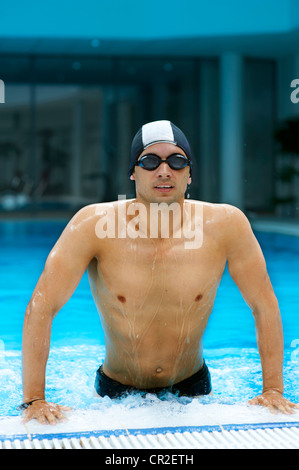 Young handsome swimmer at swimming pool Stock Photo