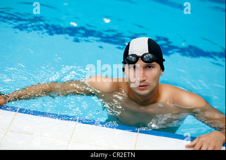 Young handsome swimmer at swimming pool Stock Photo