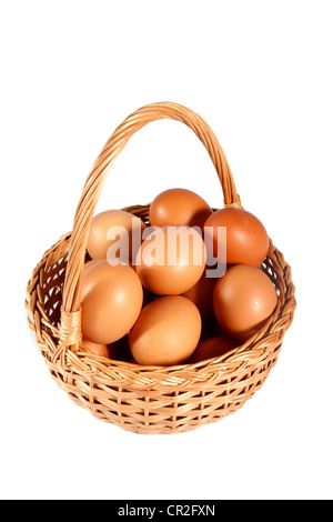 brown eggs in wicker basket on a white background Stock Photo