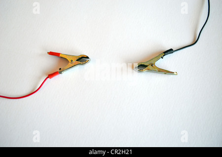 Accumulator battery charger connectors clamp. Plius and minus, red and black on white background. Stock Photo