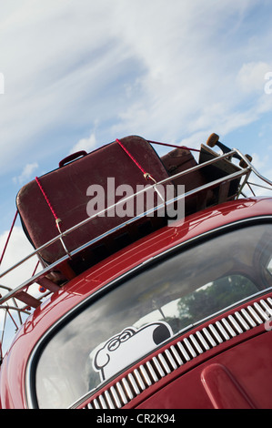 VW Volkswagen beetle car with suitcases and skateboard in the roof rack Stock Photo
