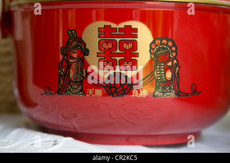 Red Chinese Double Happiness characters on a bowl symbolize marriage Stock Photo