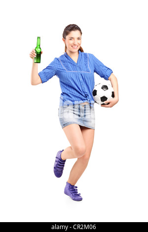 Full length portrait of a happy female fan holding a beer bottle and football isolated on white background Stock Photo