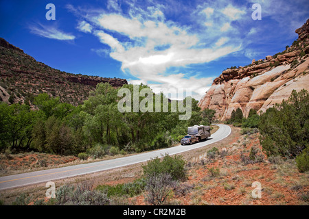 An RV navigates the narrow road in Indian Creek Canyon, Canyonlands National Park, Utah Stock Photo