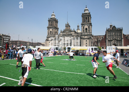 Mexican people play rugby on an artificial field on Zocalo in front of the Cathedral Metropolitana in Mexico City Stock Photo