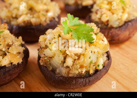 Portobello mushrooms stuffed with a mixture of pine nuts, onion, garlic and cheese. Stock Photo
