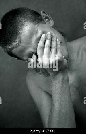 The sad man closed the face hand Stock Photo