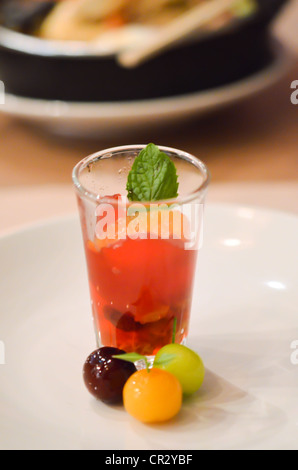 Glass of red gelatin dessert with fresh orange Stock Photo