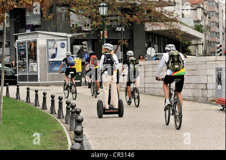 Tourists of a cruise ship riding bicycles and Segways during a shore excursion, Praca Marques de Pombal, Lisbon, Lisboa Stock Photo