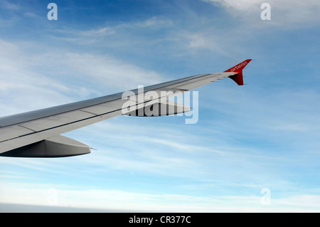 Right wing, Airbus A 319 in flight above clouds Stock Photo
