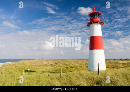 Red and white striped lighthouse of List Ost on the Sylt peninsula of Ellenbogen with the sea on the horizon, List, Sylt Stock Photo