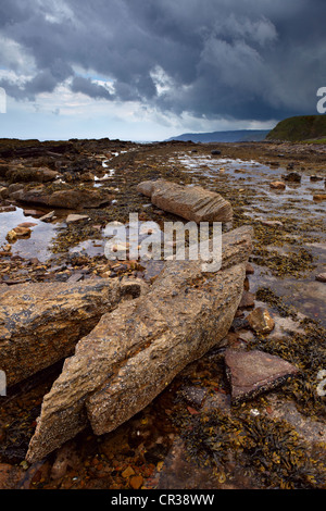 Storm clouds blow in over the coastline near Cove Harbour, Berwickshire, Scotland Stock Photo