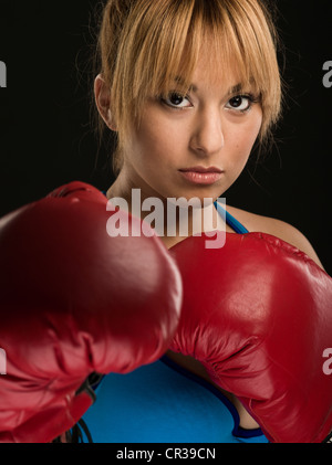 Female boxer with red boxing gloves. Stock Photo