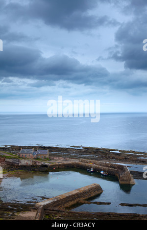 A moody spring afternoon overlooking the small harbour at Cove, Berwickshire, Scotland Stock Photo