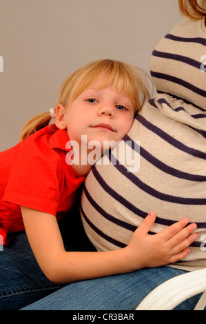 Little girl, 5 years, with her pregnant mother Stock Photo