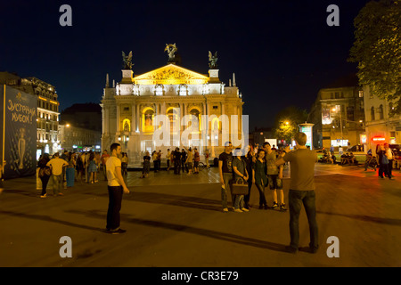 Youths taking a souvenir picture at the fountain in front of the opera house, Lviv, Ukraine Stock Photo