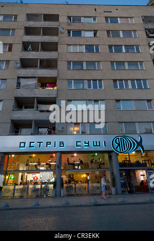 A fish restaurant under a socialist-style multi-storey building, Lviv, Ukraine Stock Photo