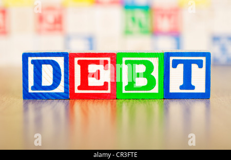Debt Spelled Out in Alphabet Building Blocks Stock Photo
