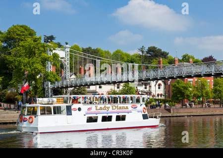 River cruise boat going under the Queen's Park suspension bridge over the River Dee Chester Cheshire England UK GB EU Europe Stock Photo