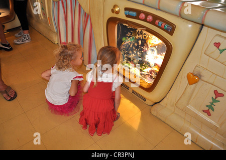 Two little girls are fascinated by the wacky dishwasher at Minnie Mouse's House, Disneyland, Anaheim, California Stock Photo