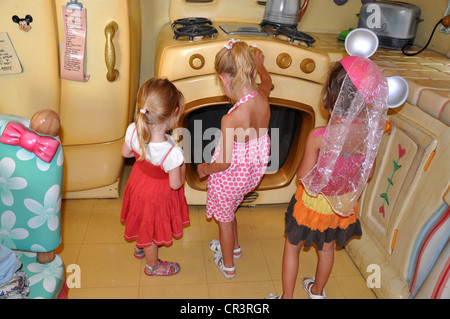 Little girls enjoy exploring Minnie Mouse's wacky Kitchen at Disneyland, Anaheim, California Stock Photo