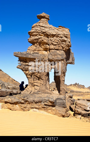 Algeria, Sahara near Djanet, Tassili N' Ajjer Massif, national park UNESCO World Heritage, rock formation and tuareg, between Stock Photo
