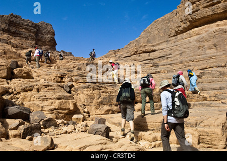 Algeria, Sahara near Djanet, Tassili N' Ajjer Massif, national park UNESCO World Heritage, hikers in sandstone rocks, between Stock Photo