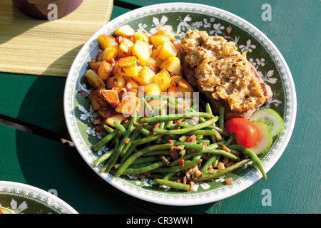 Mustard roast beef with roasted potatoes and green beans with bacon Stock Photo