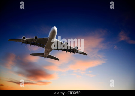 Airbus A380 jet aeroplane taking off in bright dramatic twilight sunset moody sky. Stock Photo