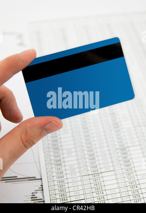 Credit, debit card in hand on business background Stock Photo