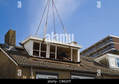 Placing the new dormer-windows on the roof. Stock Photo