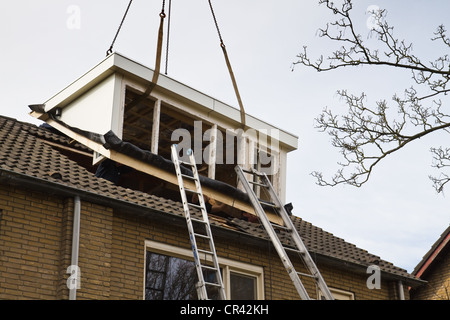 Placing new and bigger dormer-window on front side of house Stock Photo