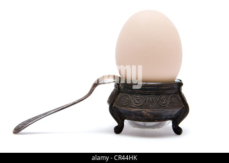 Egg in old-fashioned holder isolated on white Stock Photo