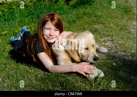 The girl and her golden retriever dog Stock Photo - Alamy