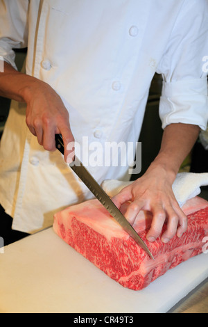 Chef Cutting Lump of Meat Stock Photo