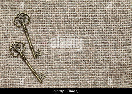 Antique key on burlap background Stock Photo
