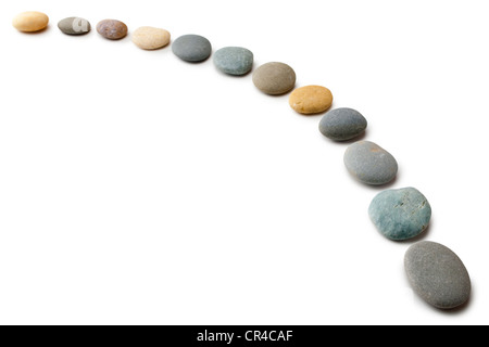 Snaking line of twelve coloured pebbles isolated on white. Stock Photo
