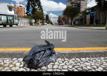 Garbage bag waiting by the roadside of a major city to be picked up, Curitiba, Parana, Brazil, South America, PublicGround Stock Photo