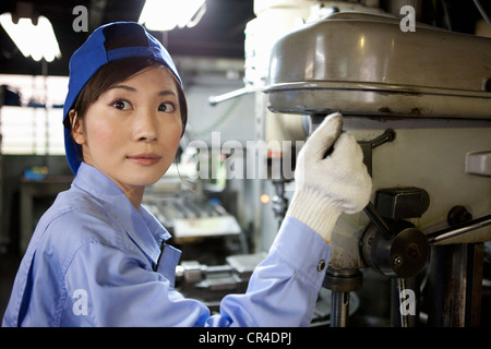 Woman factory worker operating machine, 1942 Stock Photo - Alamy