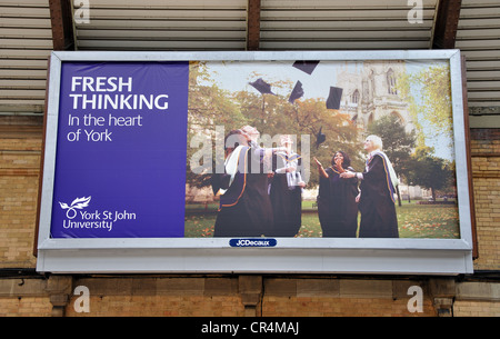 billboard on the wall of York railway station advertising York St John University, York, North Yorkshire, England, UK Stock Photo